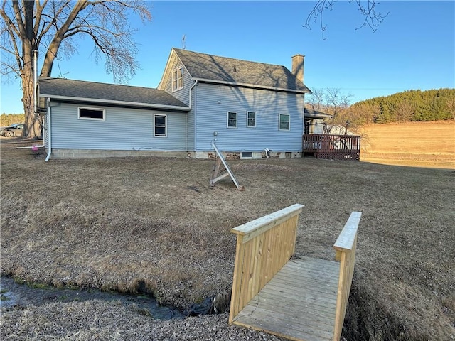 back of property featuring a wooden deck