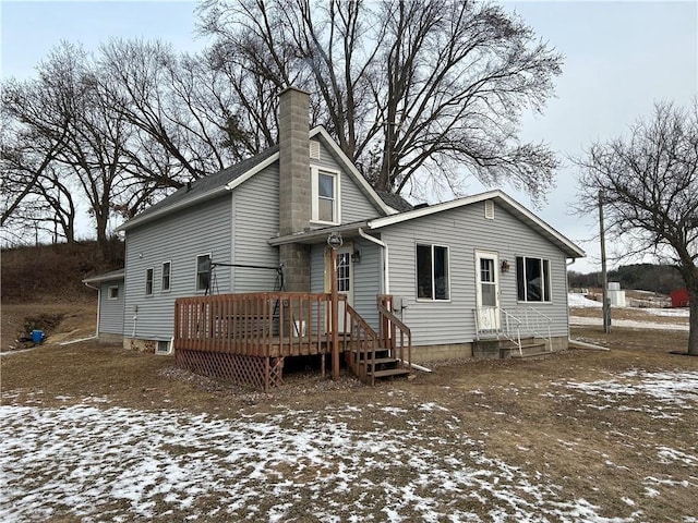 view of snow covered back of property