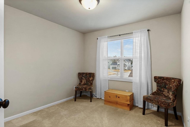 sitting room featuring light colored carpet