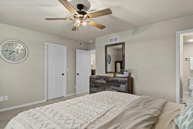 bedroom featuring ceiling fan, light colored carpet, and ensuite bathroom