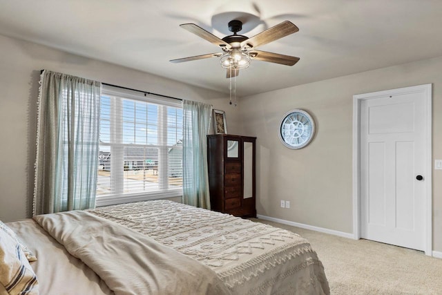 bedroom with light colored carpet and ceiling fan