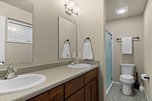 bathroom featuring vanity, toilet, a shower with shower door, and tile patterned flooring