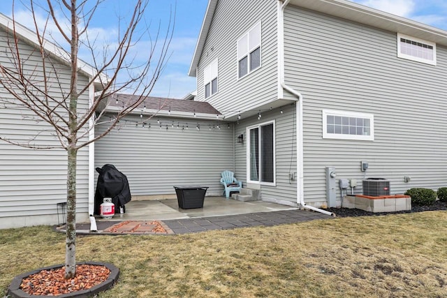 rear view of house with a yard, central AC unit, and a patio