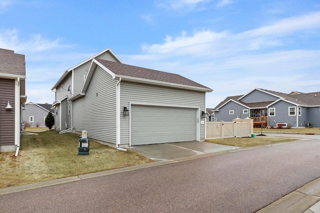 exterior space featuring a garage and a lawn