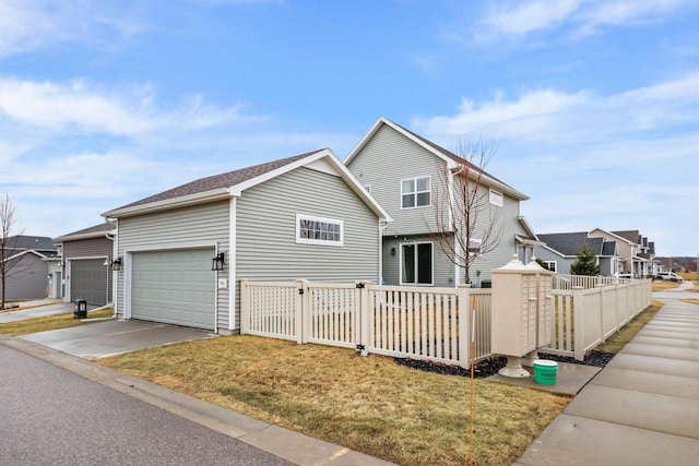 view of front of property with a garage and a front lawn