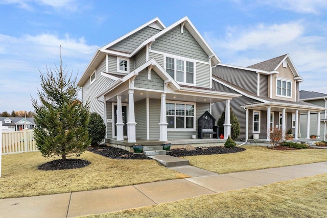 craftsman-style house with a front yard and covered porch