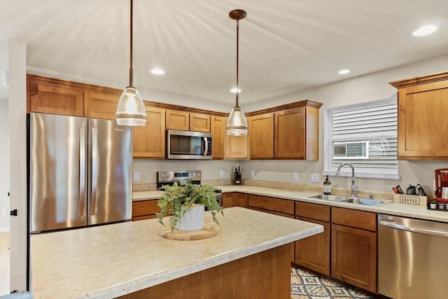 kitchen with sink, decorative light fixtures, and appliances with stainless steel finishes