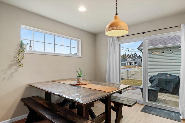 dining space with light hardwood / wood-style floors