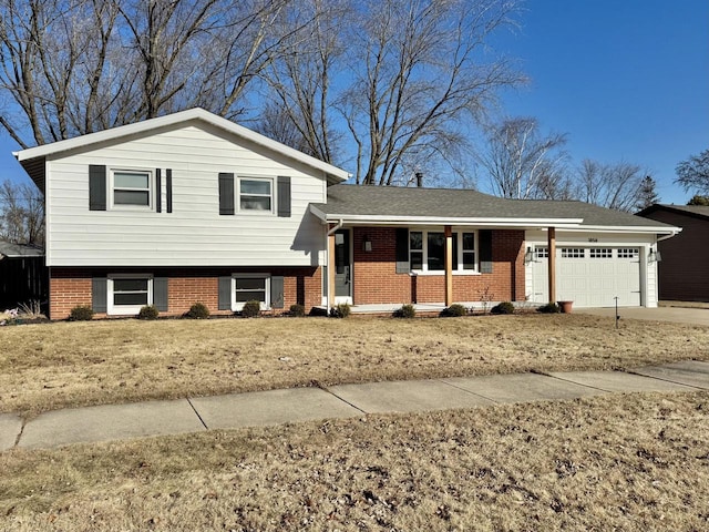 tri-level home with a garage and a front lawn