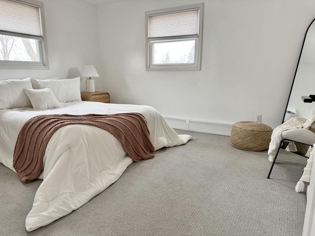 carpeted bedroom with a baseboard radiator