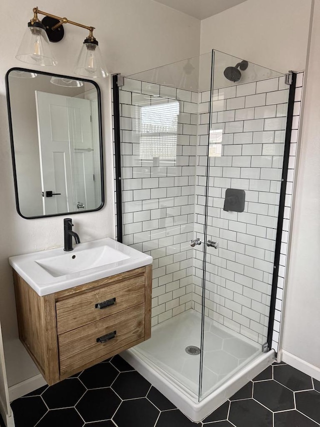 bathroom with vanity, a shower with door, and tile patterned flooring