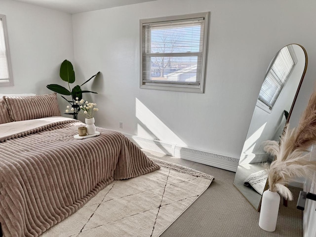 carpeted bedroom with a baseboard heating unit