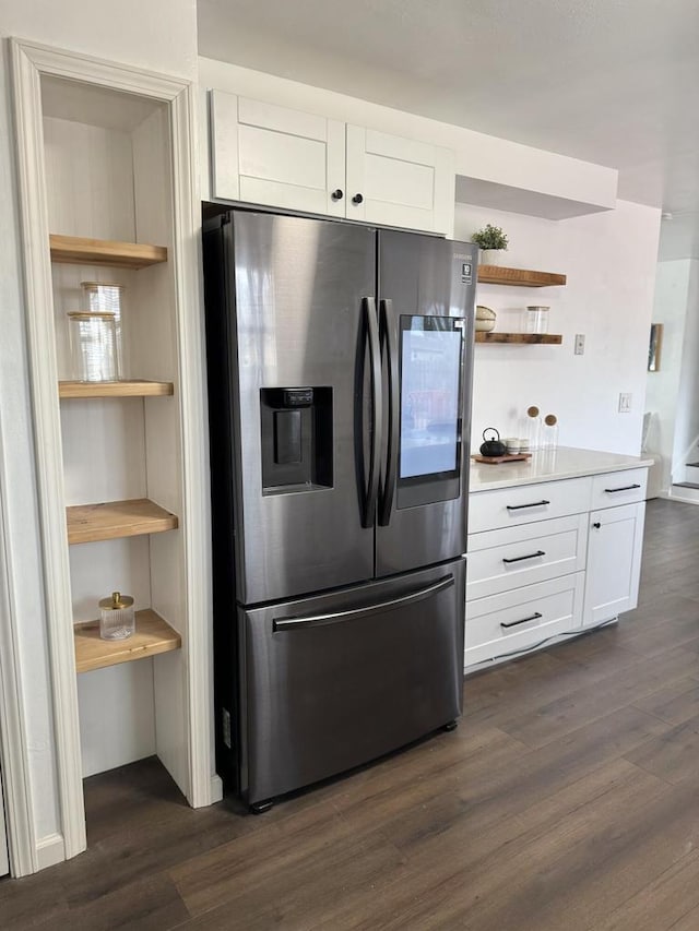 kitchen featuring dark hardwood / wood-style flooring, stainless steel fridge with ice dispenser, and white cabinets