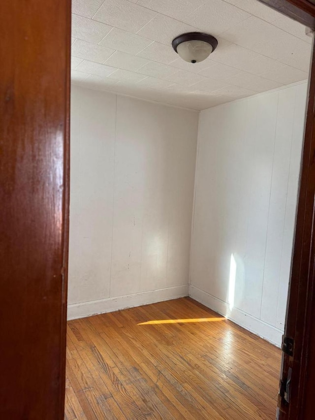 empty room with hardwood / wood-style floors