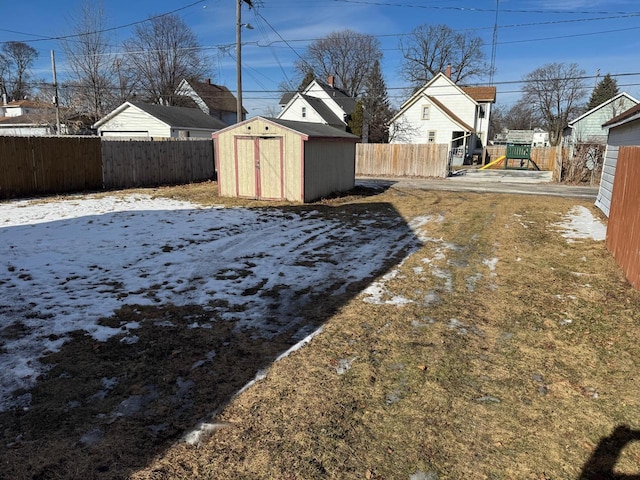 snowy yard with a shed