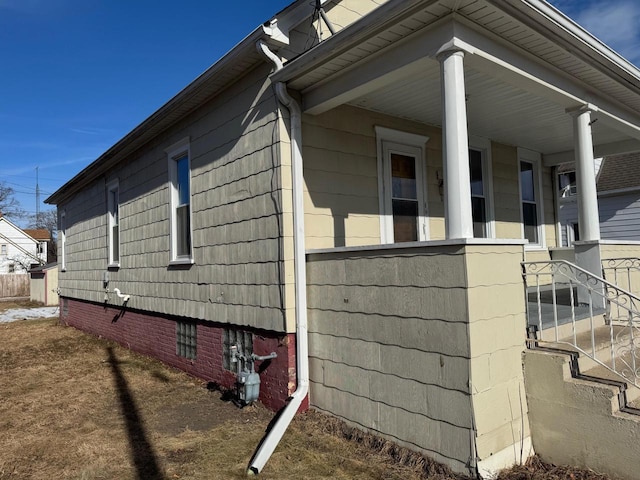 view of property exterior featuring covered porch