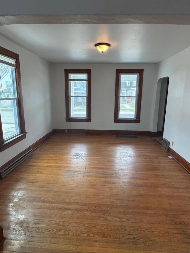 1820 54th St, Kenosha, WI 53140 - unfurnished room featuring wood finished floors, healthy amount of natural light, and arched walkways