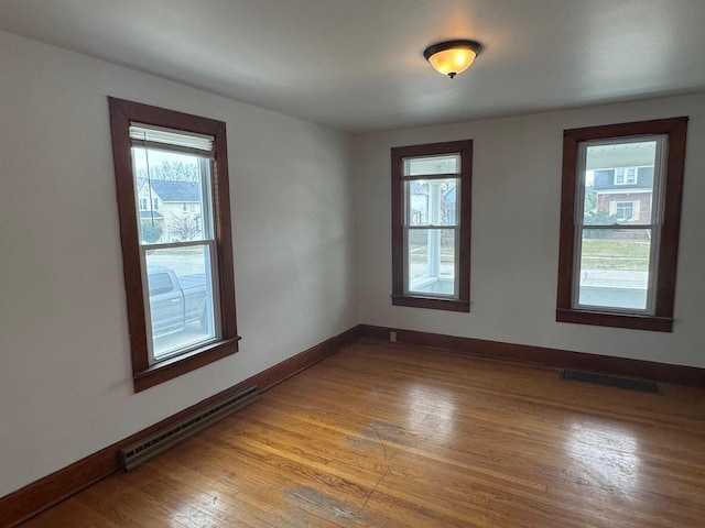 1820 54th St, Kenosha, WI 53140 - unfurnished room featuring a baseboard radiator and light wood-type flooring