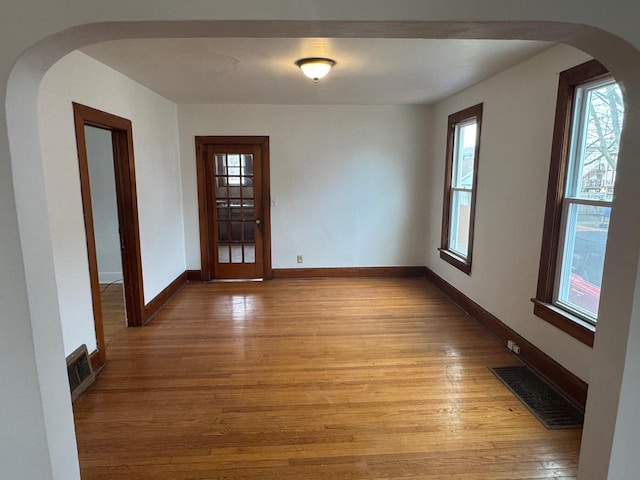 1820 54th St, Kenosha, WI 53140 - spare room featuring light wood-style flooring and arched walkways