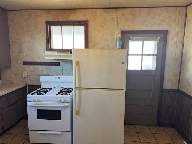 kitchen with white appliances and light tile patterned floors