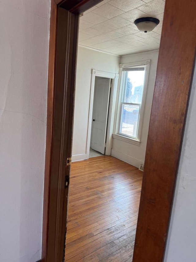 hall with hardwood / wood-style floors