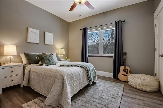 bedroom with ceiling fan and dark hardwood / wood-style flooring