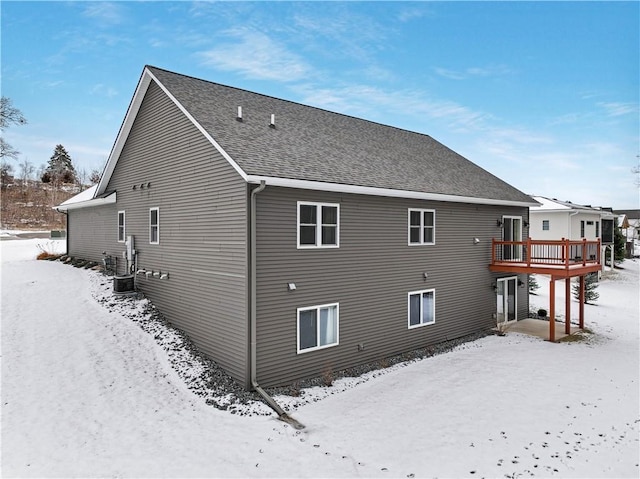 snow covered property featuring a deck