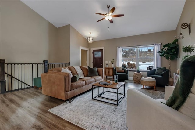 living room with hardwood / wood-style floors, high vaulted ceiling, and ceiling fan