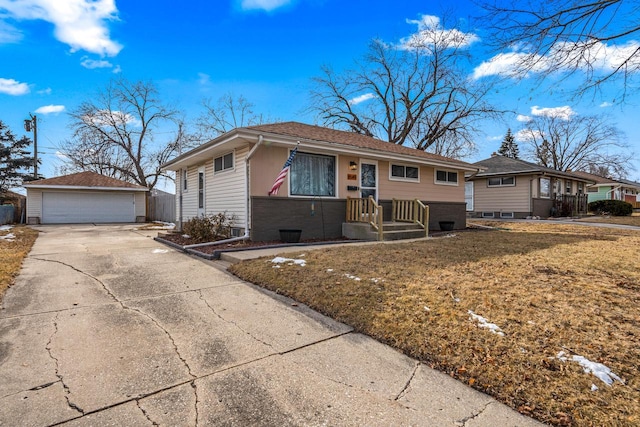 single story home featuring a garage, an outdoor structure, and a front lawn