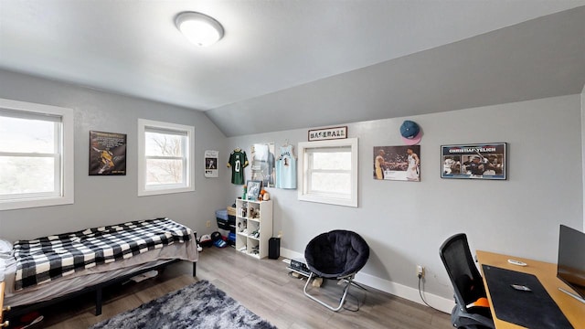 bedroom with vaulted ceiling and light hardwood / wood-style floors