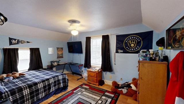 bedroom featuring vaulted ceiling and light hardwood / wood-style flooring