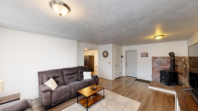 living room featuring hardwood / wood-style floors and a wood stove