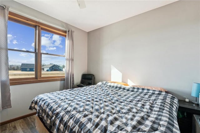 bedroom with hardwood / wood-style flooring and ceiling fan