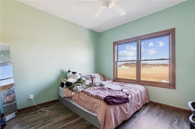 bedroom featuring ceiling fan and dark hardwood / wood-style flooring