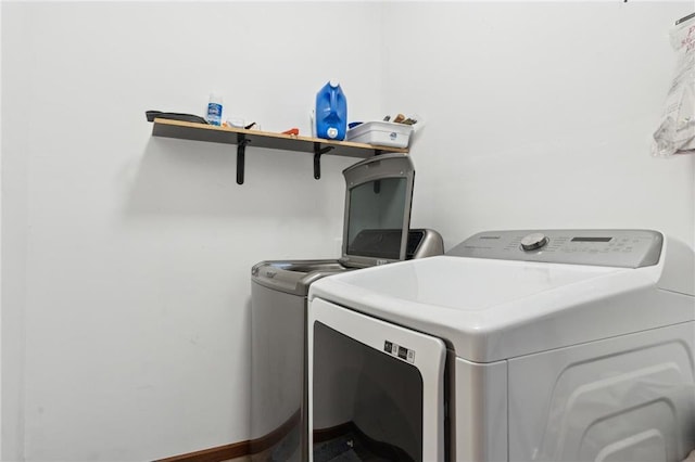 washroom with washing machine and clothes dryer