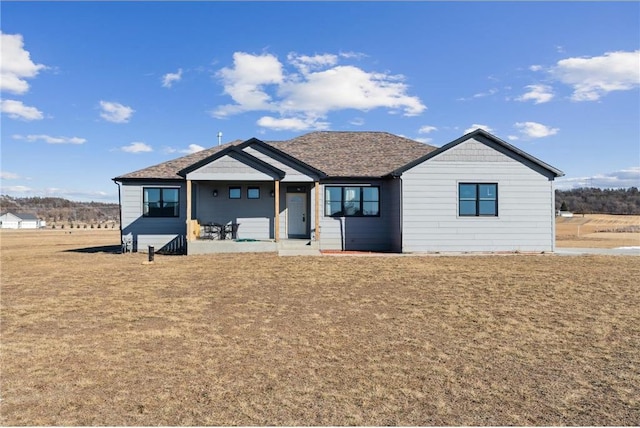 view of front of home with a patio area and a front yard