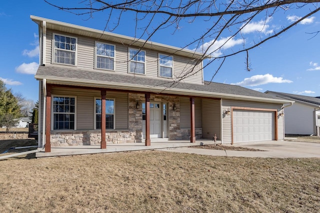 view of front property featuring a garage, covered porch, and a front lawn