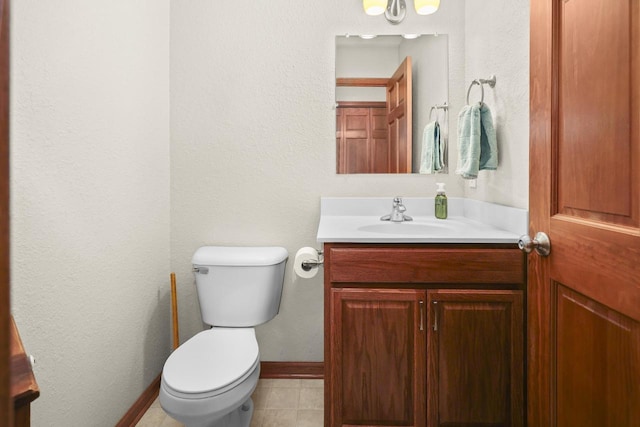 bathroom with vanity, toilet, and tile patterned flooring