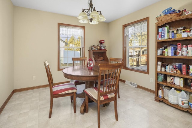 dining room featuring an inviting chandelier and plenty of natural light