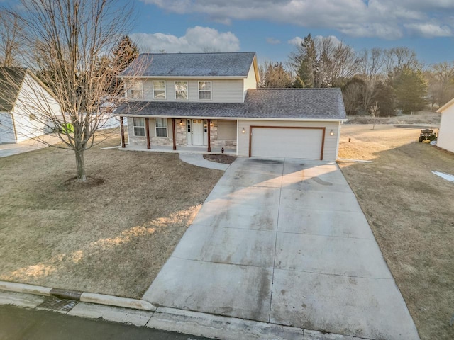 front of property featuring a garage, covered porch, and a front yard