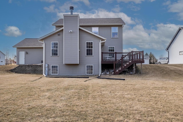 back of house featuring a yard and a deck