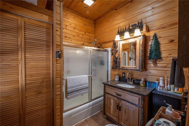 W268 County Highway A, Stone Lake, WI 54876 - bathroom featuring wood walls, shower / bath combination with glass door, tile patterned flooring, vanity, and wood ceiling