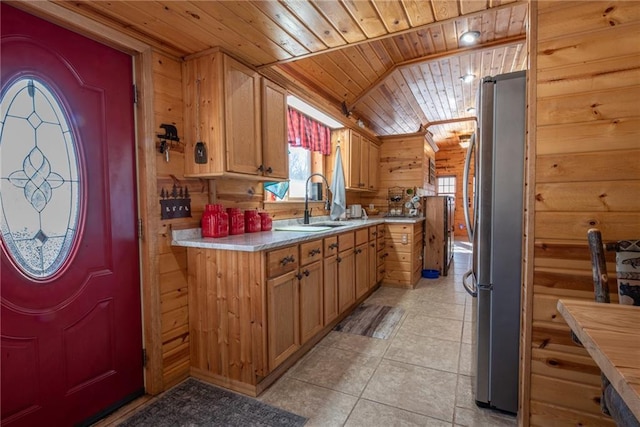 W268 County Highway A, Stone Lake, WI 54876 - kitchen with light tile patterned flooring, wooden walls, stainless steel refrigerator, sink, and wooden ceiling