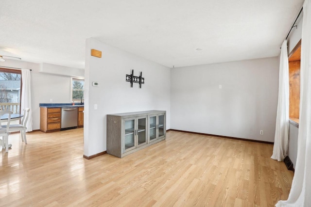 spare room with ceiling fan and light wood-type flooring