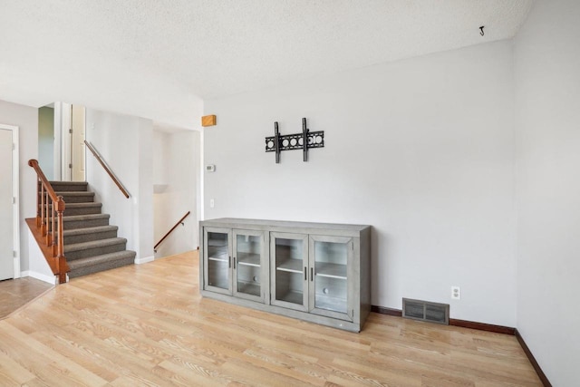 interior space featuring light hardwood / wood-style floors and a textured ceiling