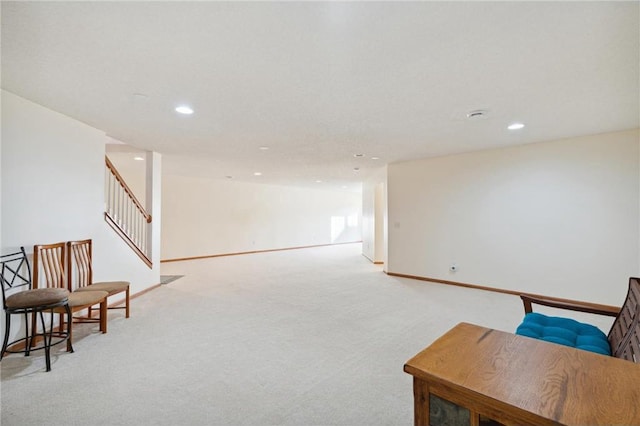 living area featuring light carpet