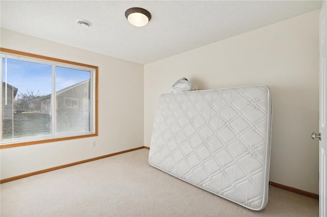 unfurnished bedroom with carpet and a textured ceiling