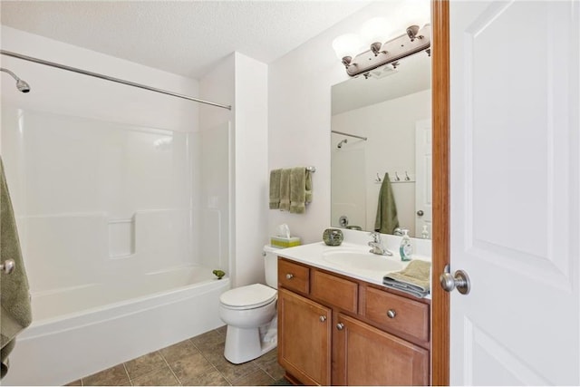 full bathroom with tile patterned flooring, vanity, toilet, bathing tub / shower combination, and a textured ceiling