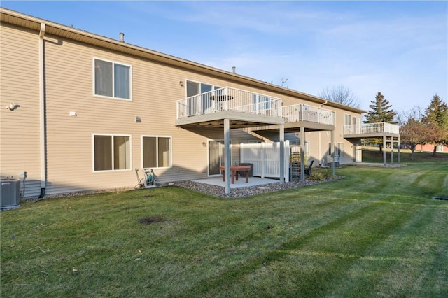 rear view of property with a yard, a patio area, and central air condition unit