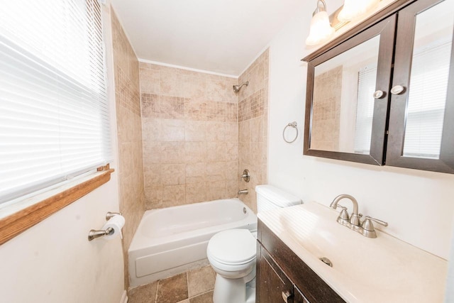 full bathroom featuring vanity, toilet, tiled shower / bath combo, and tile patterned flooring